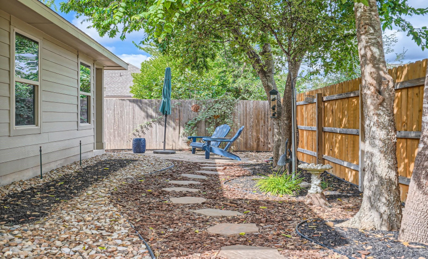 Secondary yard space with pathway to owner's suite patio
