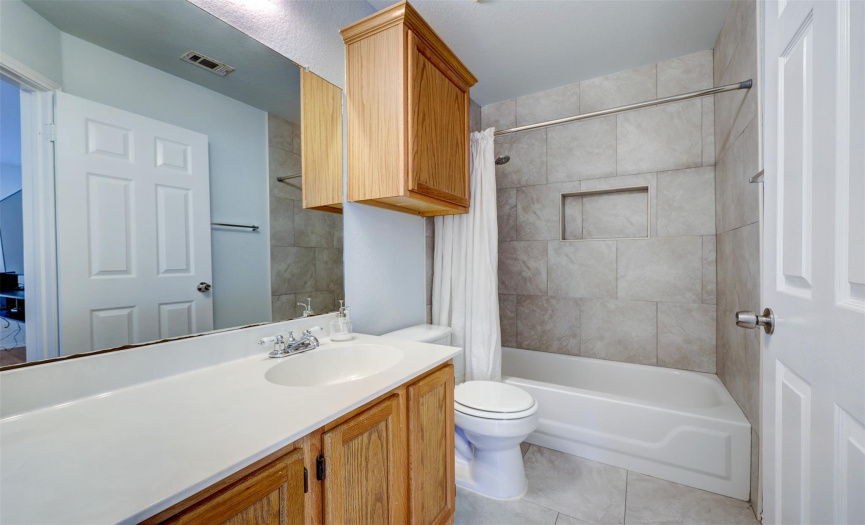 The upstairs bathroom is spacious with plenty of counter space