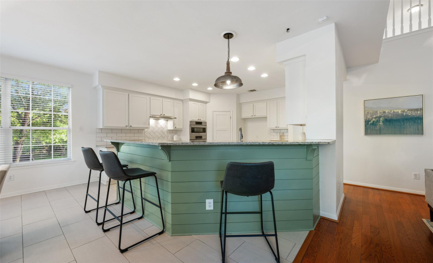 Kitchen is open to family room with a large breakfast bar.