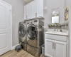 Located at garage entrance, utility has sink and washer and dryer to convey