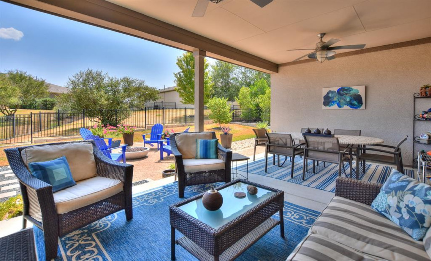Covered back patio with ceiling fans and plenty of space for your entertaining needs