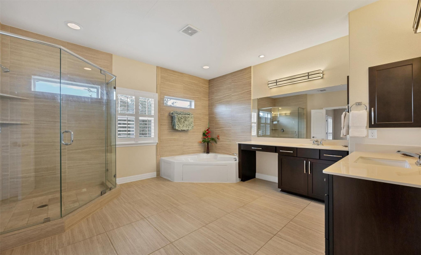 Your spa-like ensuite has a his/her double vanity, a luxurious soaking tub, a large walk-in shower, and a WIC with thoughtful drawers and shelves.  