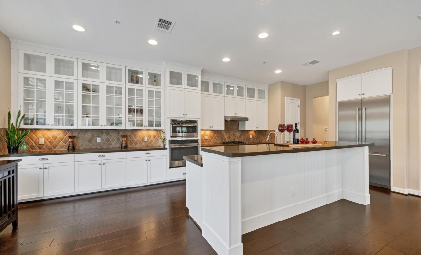 Your kitchen is stunning! It features white and glass-doored cabinets. 