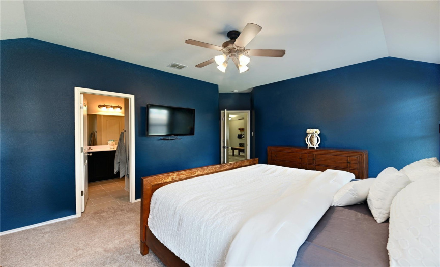 The primary suite provides plenty of space for a king sized bed, furniture, and a seating area. 