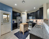Bright & spacious kitchen with SS appliances & granite countertops. 
