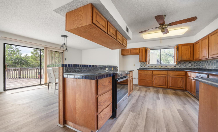 The partially updated kitchen features a new Kenmore Elite range, new Bosch dishwasher, and granite counter tops.