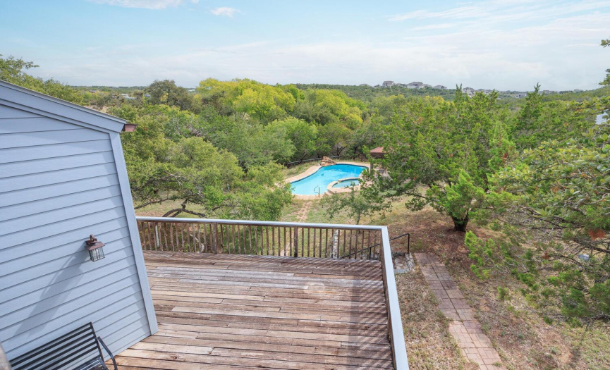 Balcony view of the pool and Hill Country, and the large deck on the main floor.