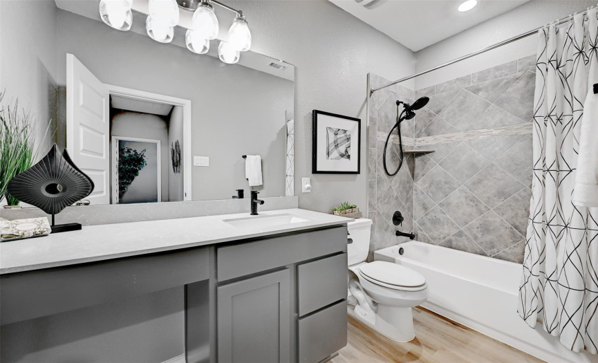 The secondary bathroom is updated and conveniently placed among the secondary bedrooms.