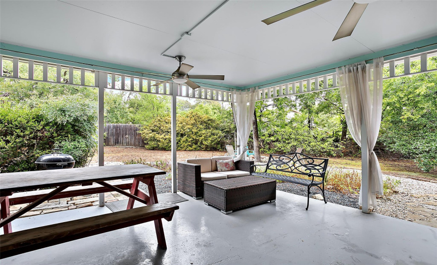 The outdoor patio has two ceiling fans and a view of this fantastic outdoor space!