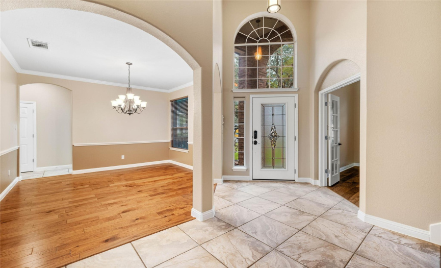 This two story entry opens into a formal dining and private study.