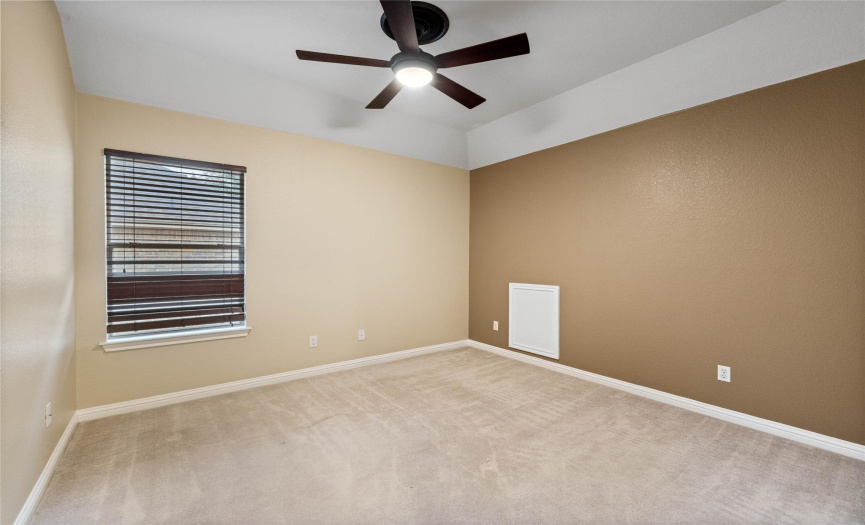 Rear upper bedroom with ceiling fan, deisgner paint and walk-in closet.