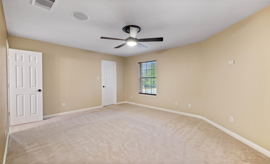 Upper front bedroom with a walk-in closet, ceiling fan, audio/visual components and ceiling fan.