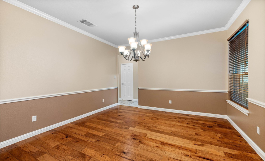 The formal dining off the entry has it's own entrance directly to the kitchen.  Complete with designer paint and wide plank hardwood flooring.