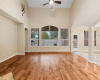 Two story great room with hardwood flooring and surround sound audio.