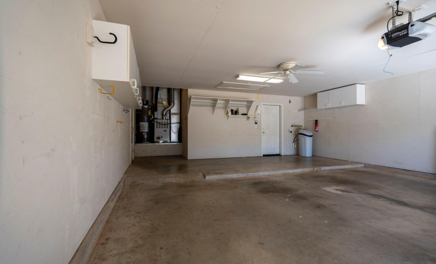 The extended garage has golf cart parking and a side exit door. 