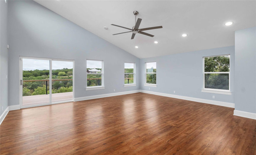 Spacious upstairs family/game room and balcony showcase panoramic views of the lake and surrounding Hill Country