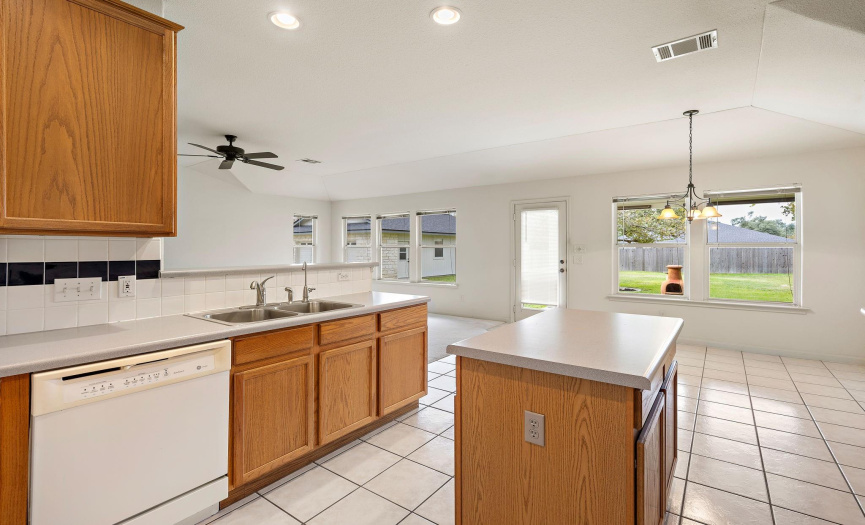 The kitchen has a lot of prep space. It offers a gas cooktop and a built-in oven and microwave. It offers lots of storage cabinets and a walk-in pantry!
