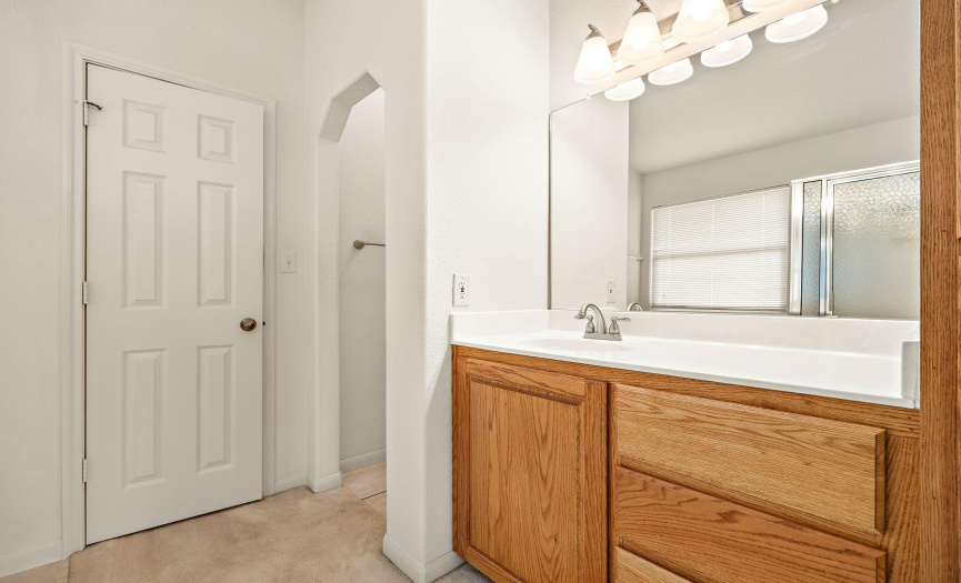 The primary bathroom has a raised sink, drawers for storage, a garden soaking tub, and a walk-in shower!