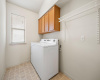 The laundry room is on the guest hall and has cabinets for extra storage!