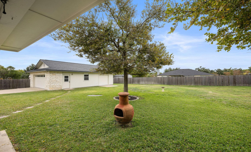 The backyard of this home is spectacular! There is plenty of space to run and play, put in a pool, or just enjoy the lush grass and raised garden!