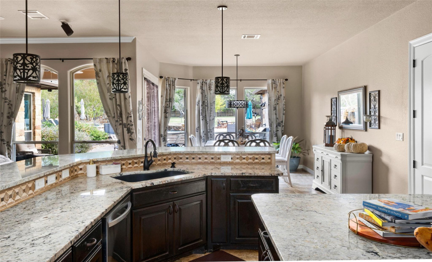 The kitchen overlooks the breakfast area and features great views to the lush backyard.