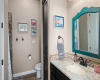 The secondary suite bathroom features a tiled walk-in shower and custom storage.