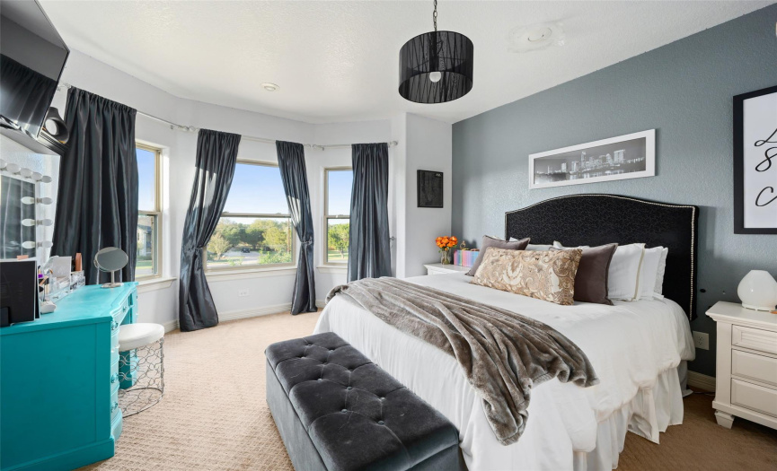 The bay window on the front of the home fills this beautiful bedroom with light!
