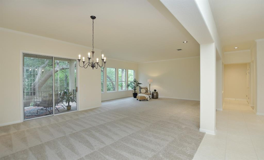 The generous combination living/dining area is found off the main hallway and touts beautiful views of the woods out back.