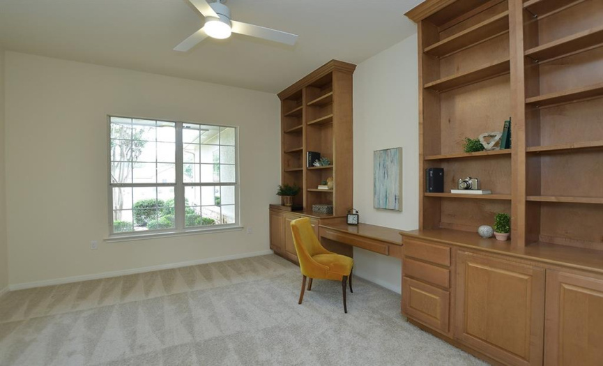 The perfect spot to work on your laptop exists between generous built-ins in the study.