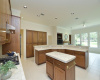 Multiple can lights provide good lighting to workspaces in the large island kitchen.