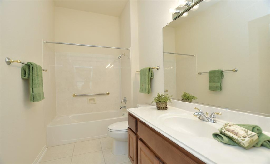 Neutral colors provide a blank canvas for your decorating choices in the guest bath.
