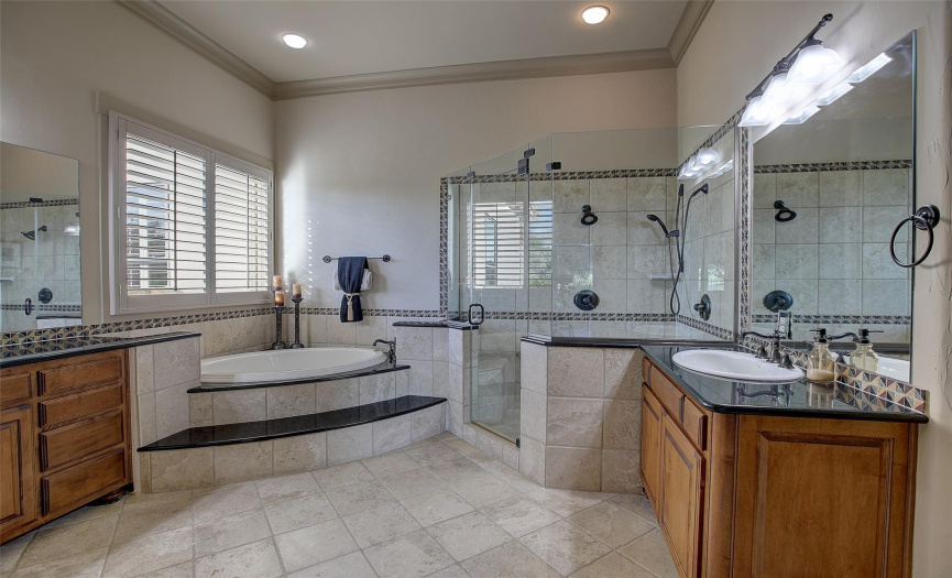 Primary bath with dual vanities, large walk in shower and tub.