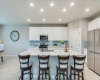 White cabinets, recessed lighting and stainless steel appliances
