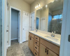 Double vanity with lots of storage and quartz countertop.