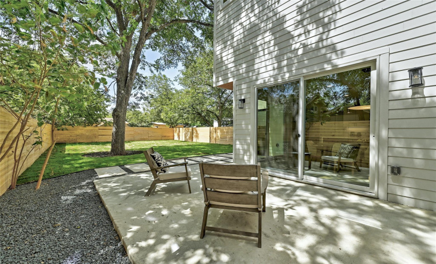 Wonderful back patio perfectly located under the large tree. Makes a great extension off the kitchen/dining room... bringing the indoors outdoor!