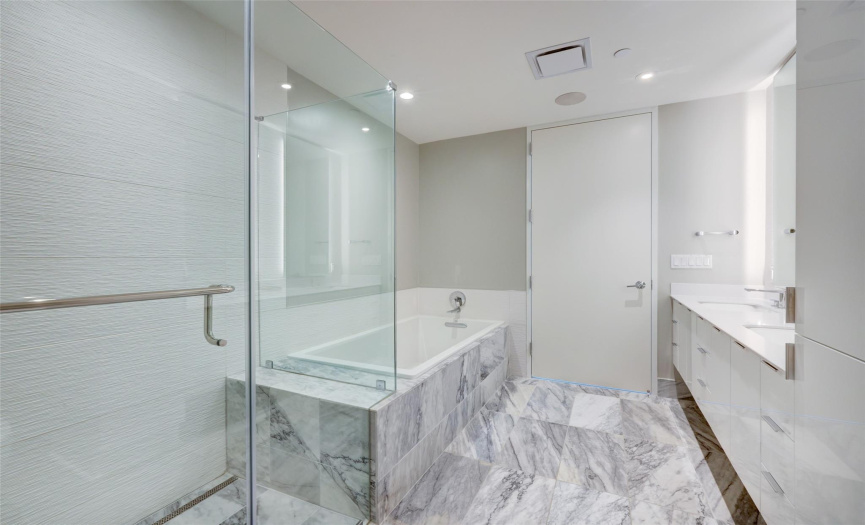 Separate walk-in shower and tub in primary bathroom