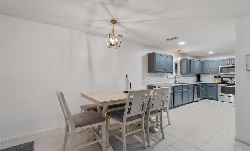 The dining area opens to both the kitchen and living room, tying the spaces together and making entertaining a breeze. Access the covered back porch from the dining area, which is perfect for grilling out. 