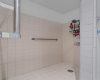 The spacious walk-in shower preserves the chic retro 80s tile work commemorating the original beauty of the home. 