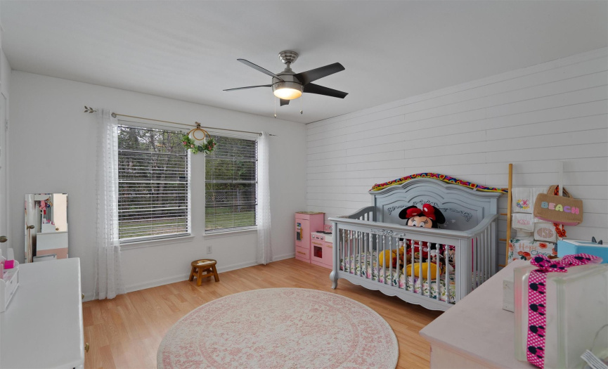 This home also provides two generously spaced secondary bedrooms. This room offers beautiful modern updated including a shiplap accent wall and modern ceiling fan. 