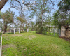 This large fenced-in yard offers two side yards with this being the largest. Perfect for pets, gardening, and more. 