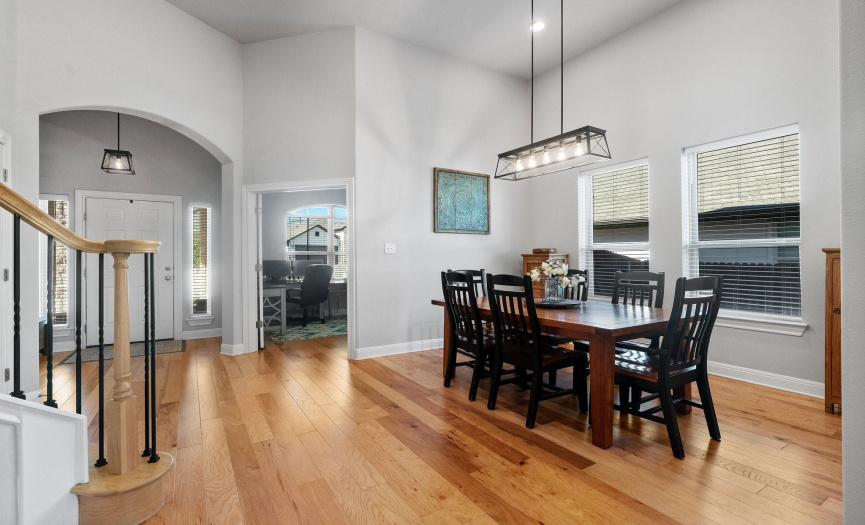 The open and airy floor plan is complemented by high ceilings, gorgeous hardwood flooring, and a neutral paint palette that enhances the abundance of natural light throughout.