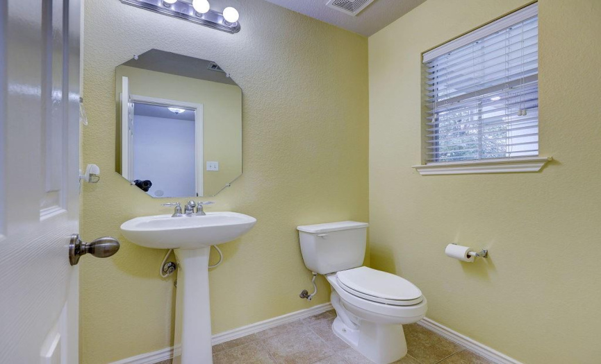 The half bath downstairs sits just off the entryway