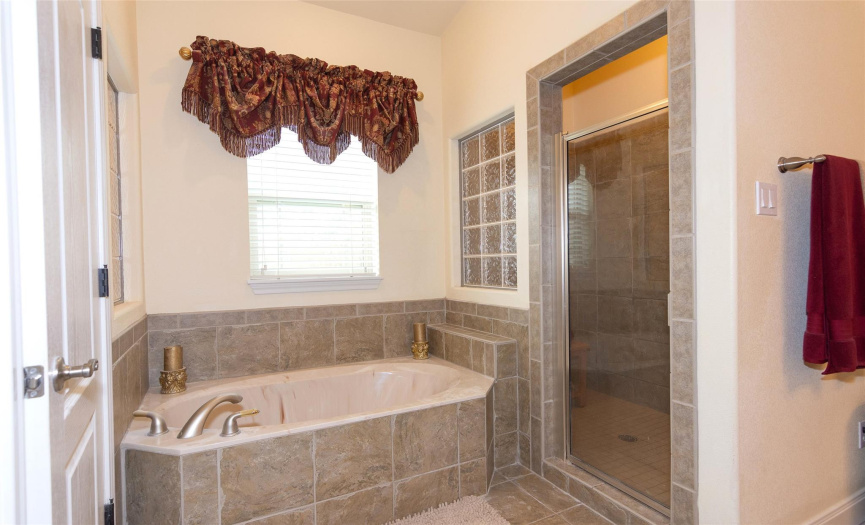 Primary bath with separate shower and tub and double vanity.