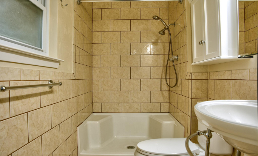 Primary Bath has Step-In Shower and Pedestal Sink 