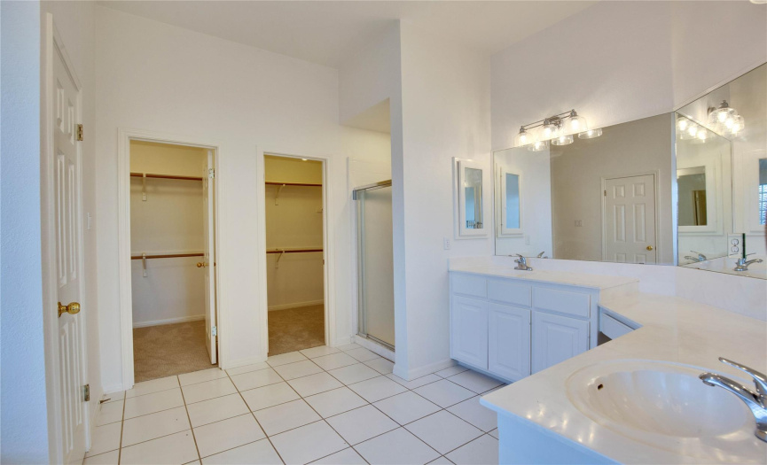 Primary bathroom, new light fixtures, two closets, shower, private bathroom to the left, jetted bathtub to the left