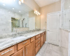 Outstanding remodel for the primary bath, huge walk-in shower and privacy screen. Gleaming countertops and beautiful hardware pulls