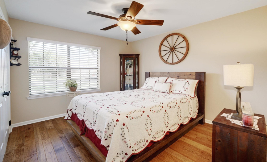 bedroom with custom blinds and ceiling fan
