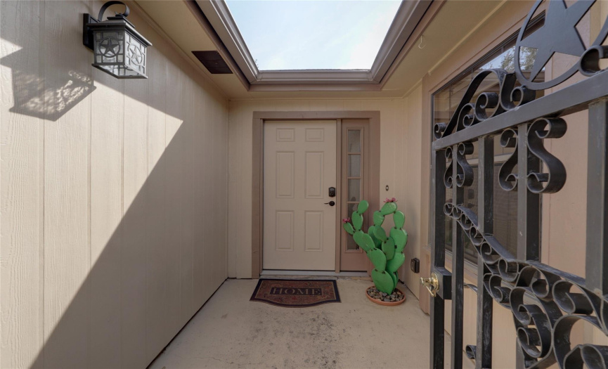gated entry to front door of home-interior of home has no stairs