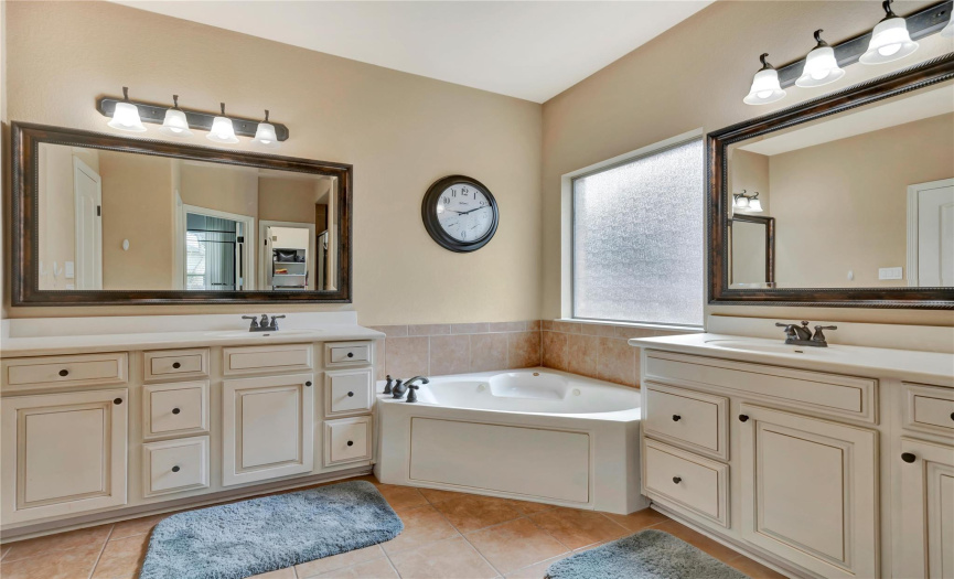 Dual vanities, soaking tub and shower in primary suite. 