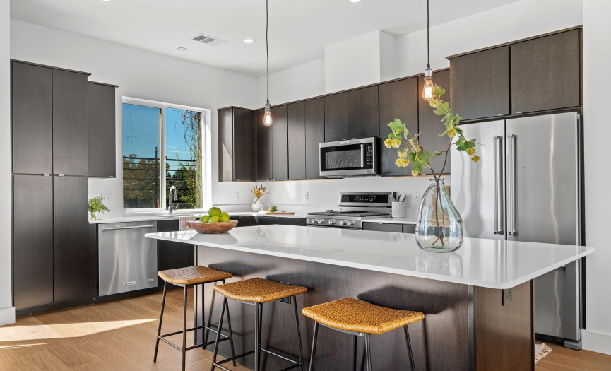 When you are not out enjoying the plethora of local eateries within walking distance from the condo, you can whip up your favorite culinary delights in this stunning gourmet kitchen. 